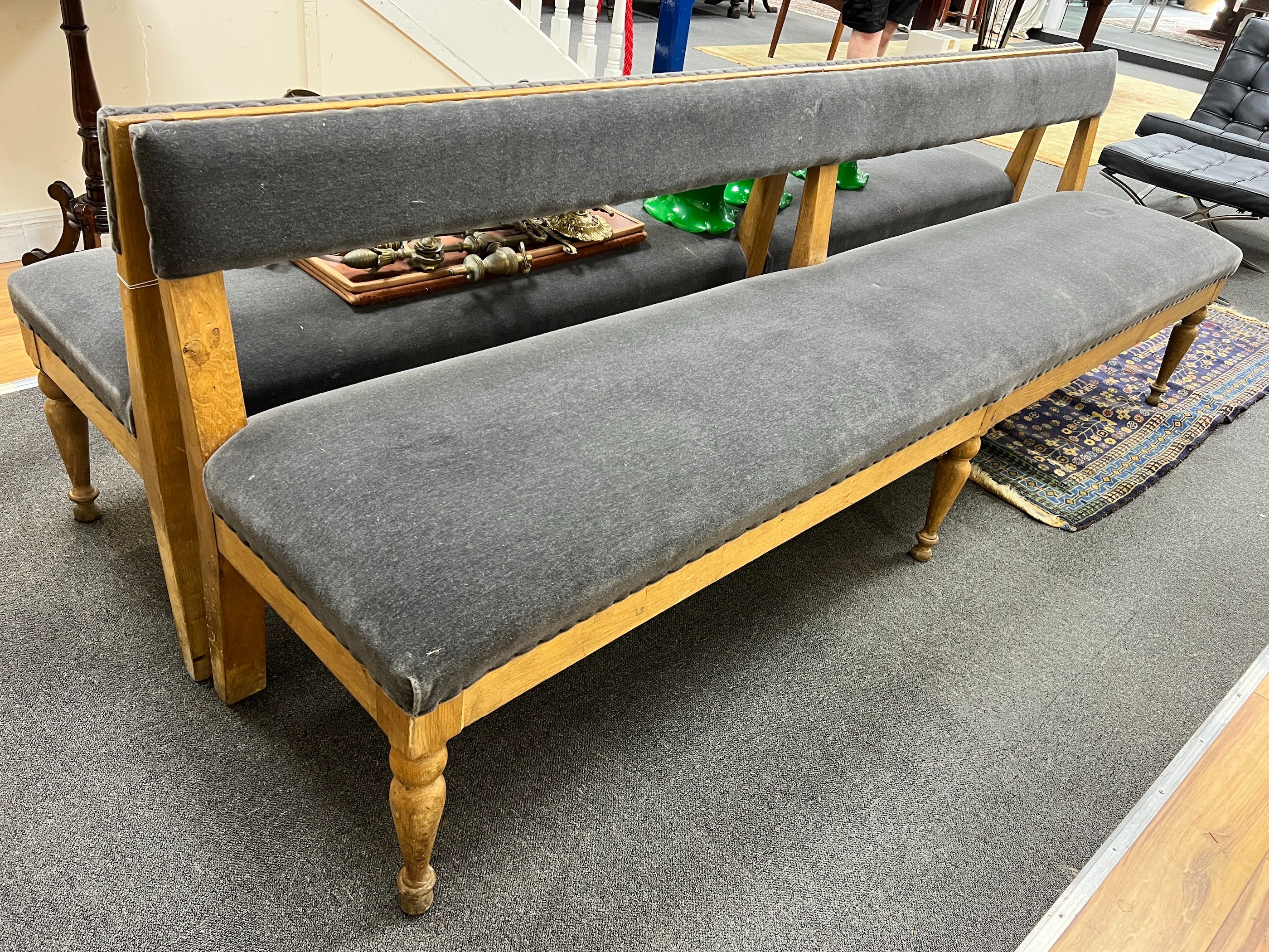 A pair of late Victorian pale oak upholstered benches, length 242cm, depth 48cm, height 80cm